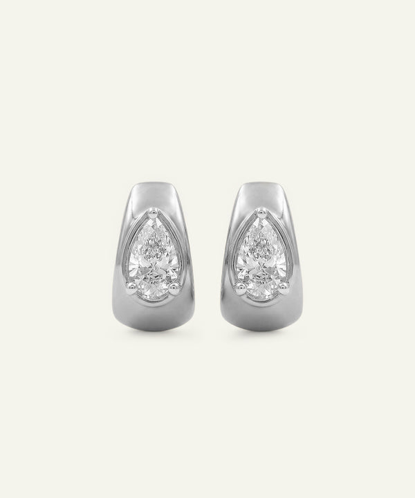 Pair of silver earrings with pear-shaped gemstones on a white background