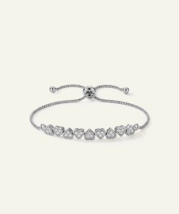 Silver bracelet with heart-shaped gemstones on a white background
