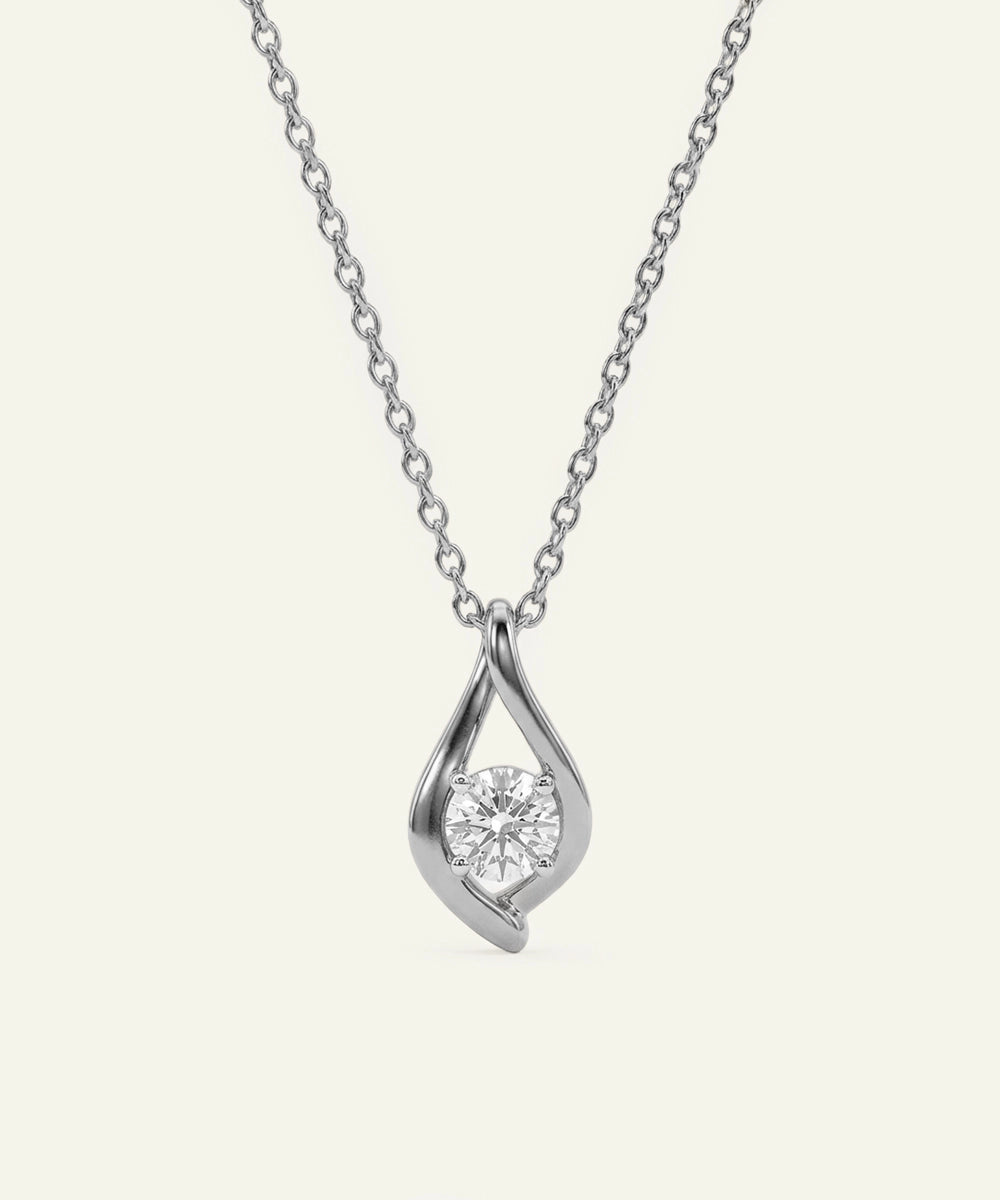 Silver necklace with a teardrop-shaped pendant on a light gray background