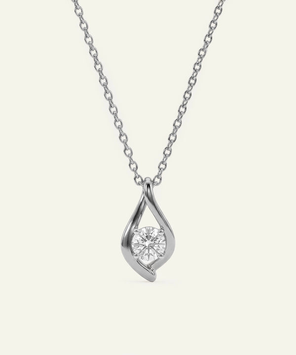 Silver necklace with a teardrop-shaped pendant on a light gray background