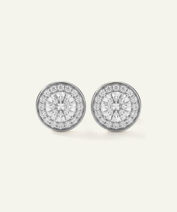 Pair of diamond stud earrings on a light gray background
