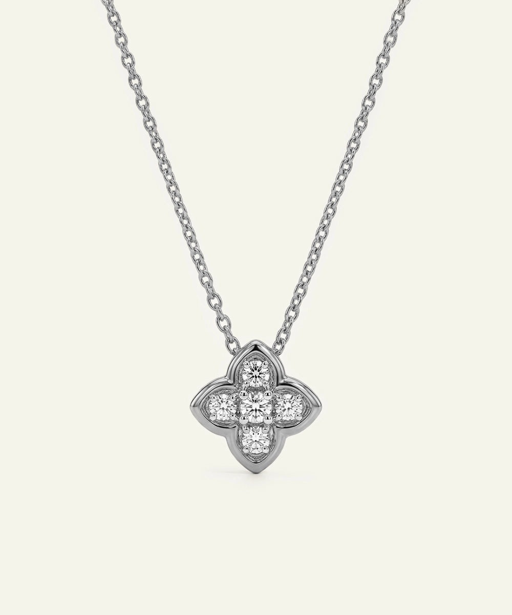 Silver necklace with a clover-shaped pendant on a white background