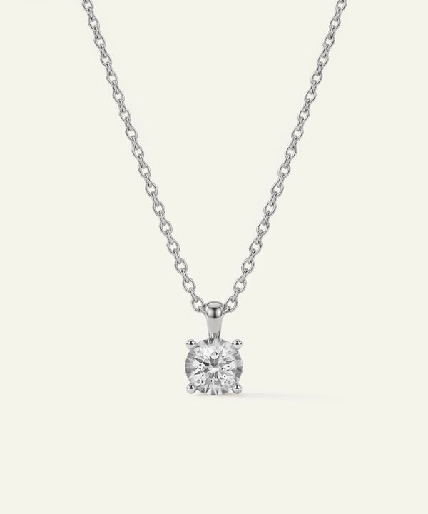 Diamond pendant necklace on a white background