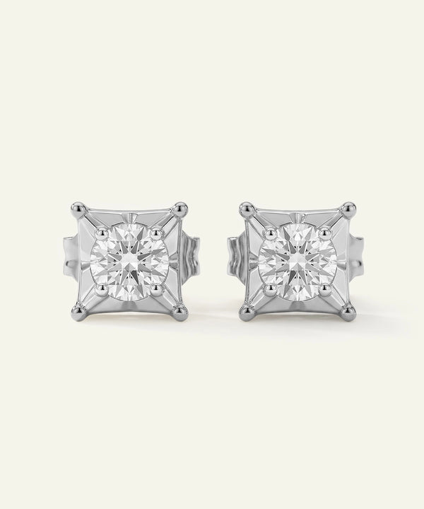 Pair of diamond stud earrings on a white background
