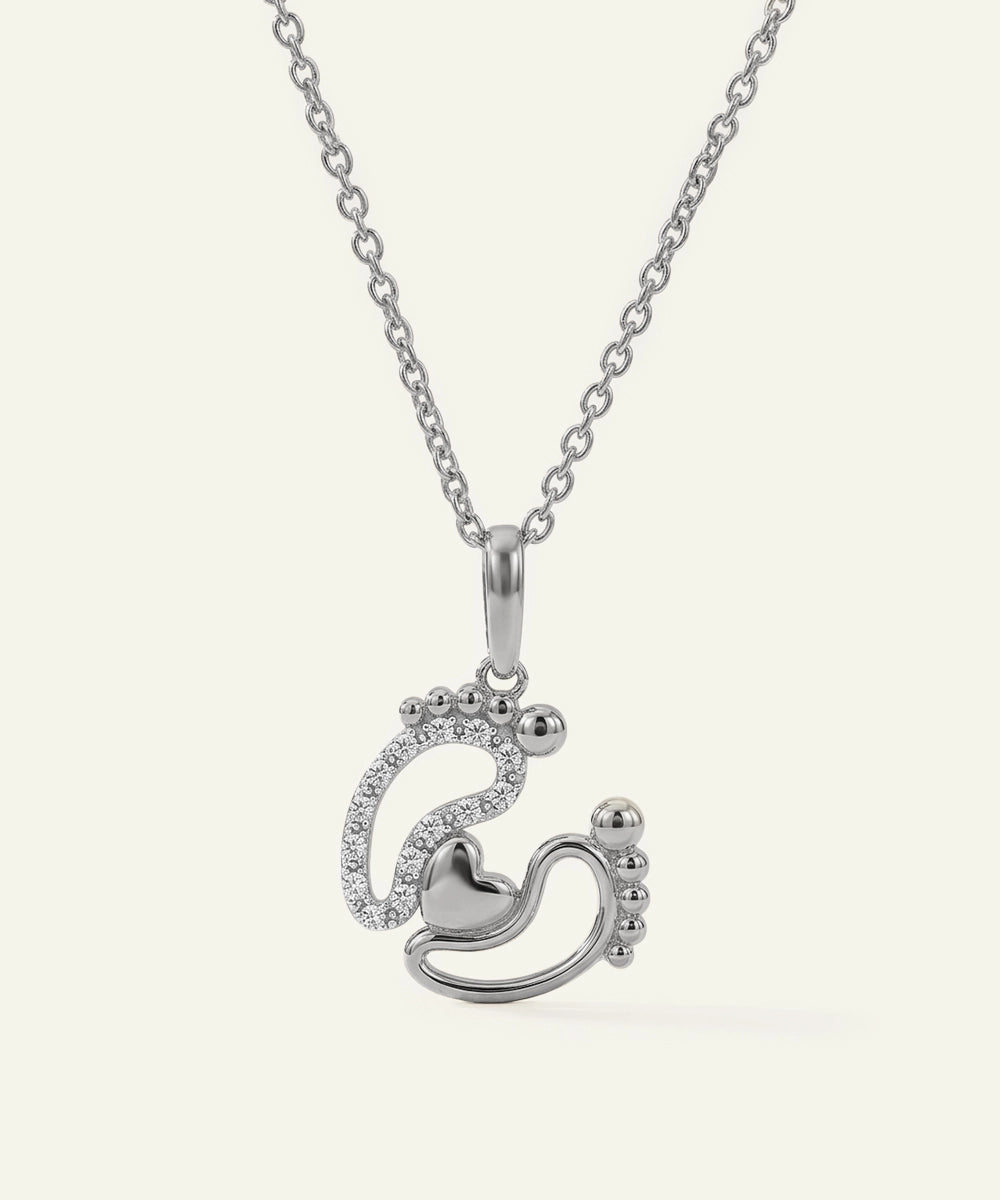 Silver necklace with a heart-shaped pendant on a white background