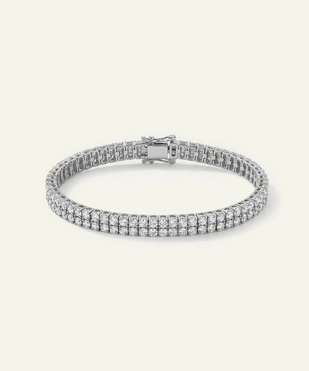 Silver bracelet with clear stones on a light gray background