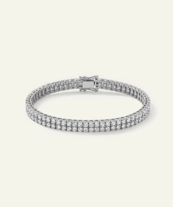 Silver bracelet with clear stones on a light gray background
