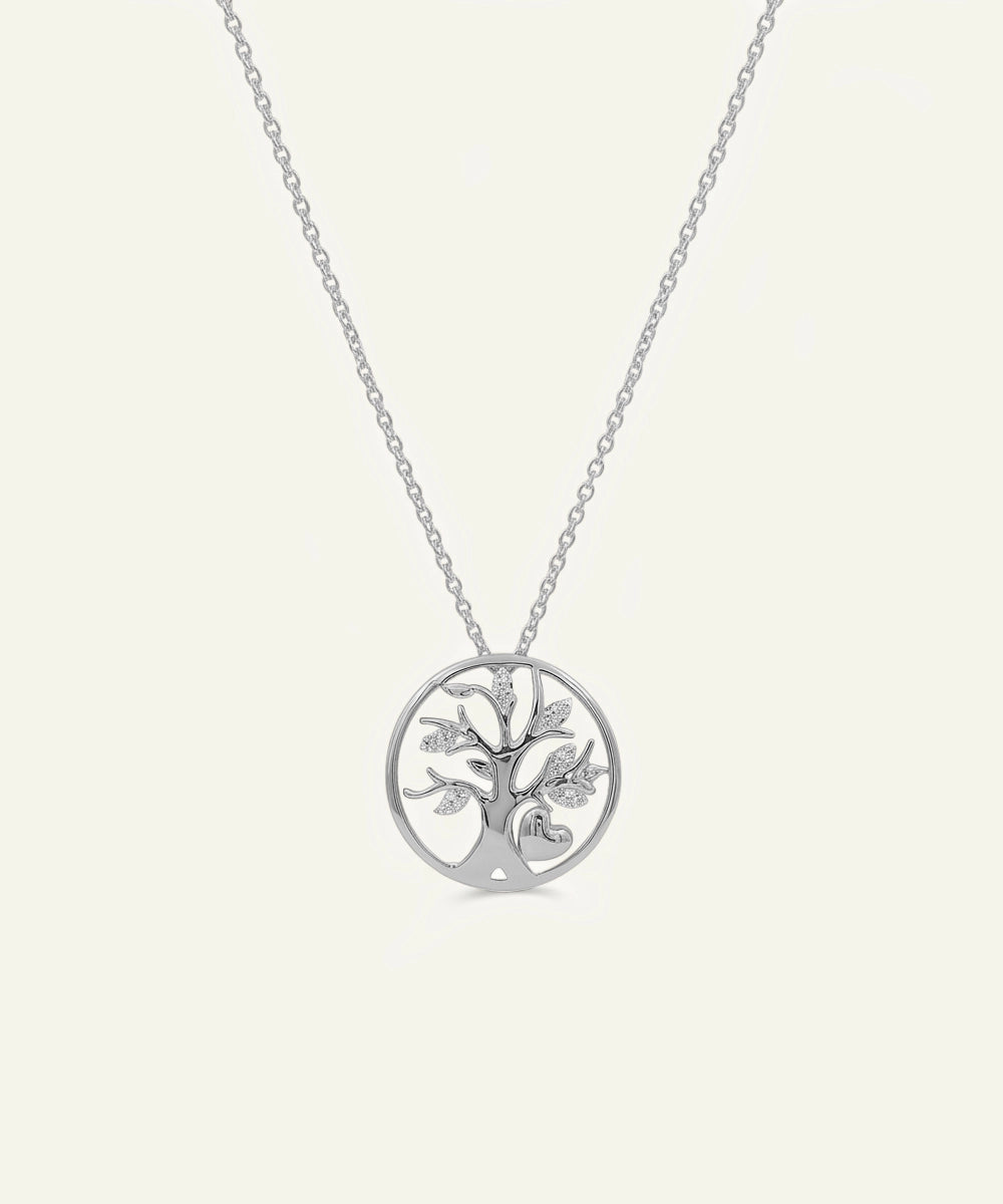 Silver tree of life pendant on a chain against a white background