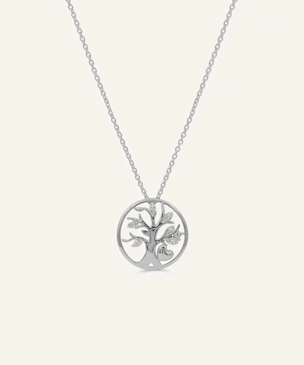 Silver tree of life pendant on a chain against a white background