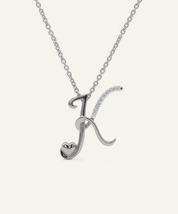 Silver necklace with a letter 'K' pendant on a white background