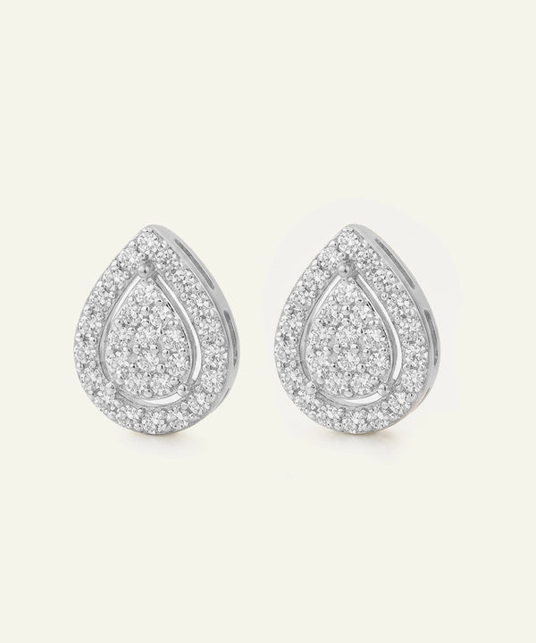 Teardrop-shaped earrings with diamond accents on a light gray background