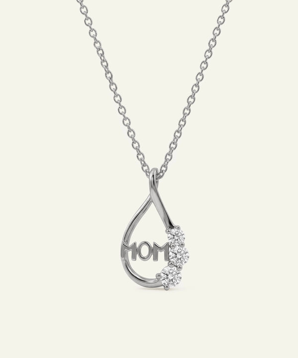 Silver necklace with 'MOM' pendant on a white background