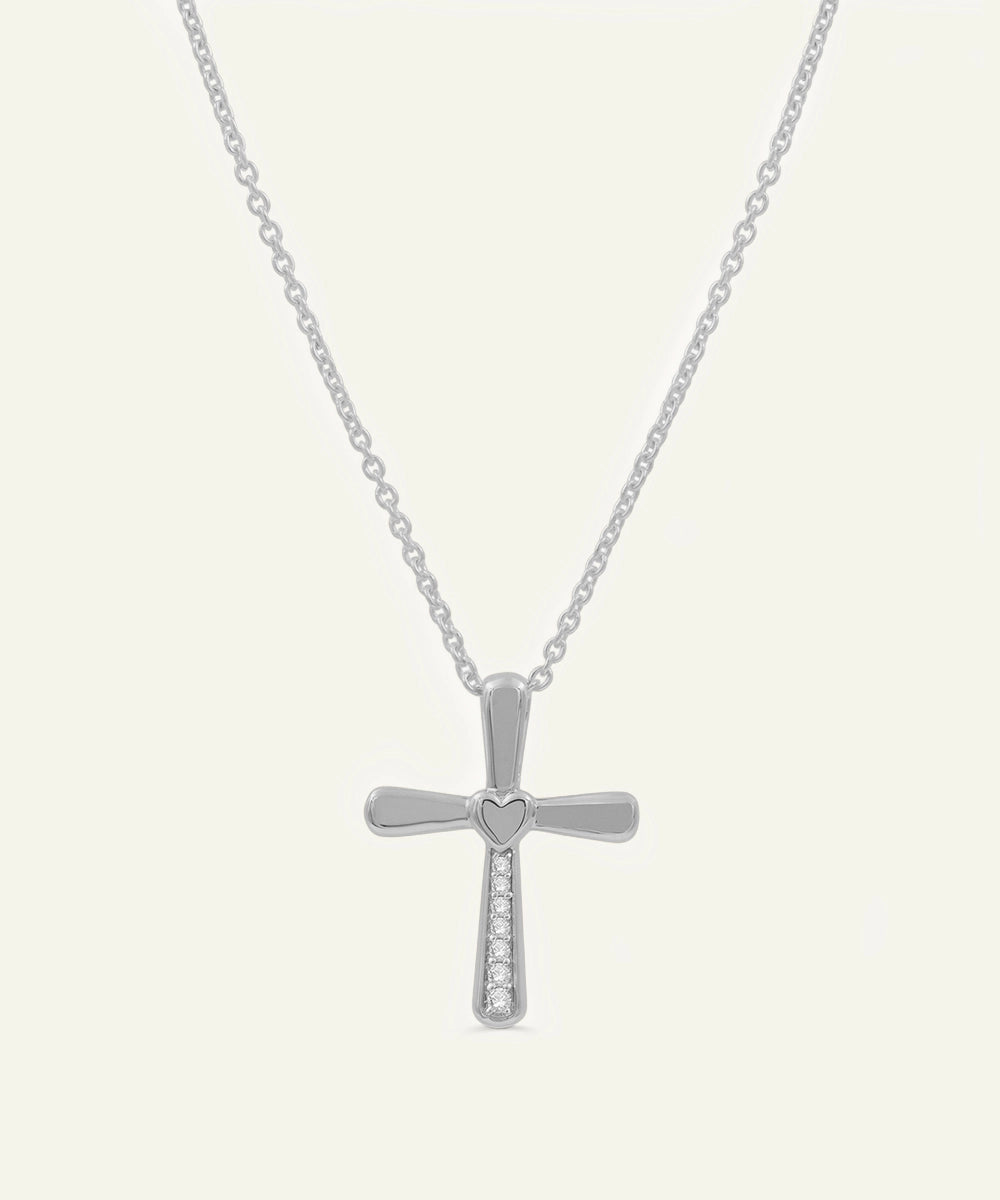 Silver cross necklace on a white background