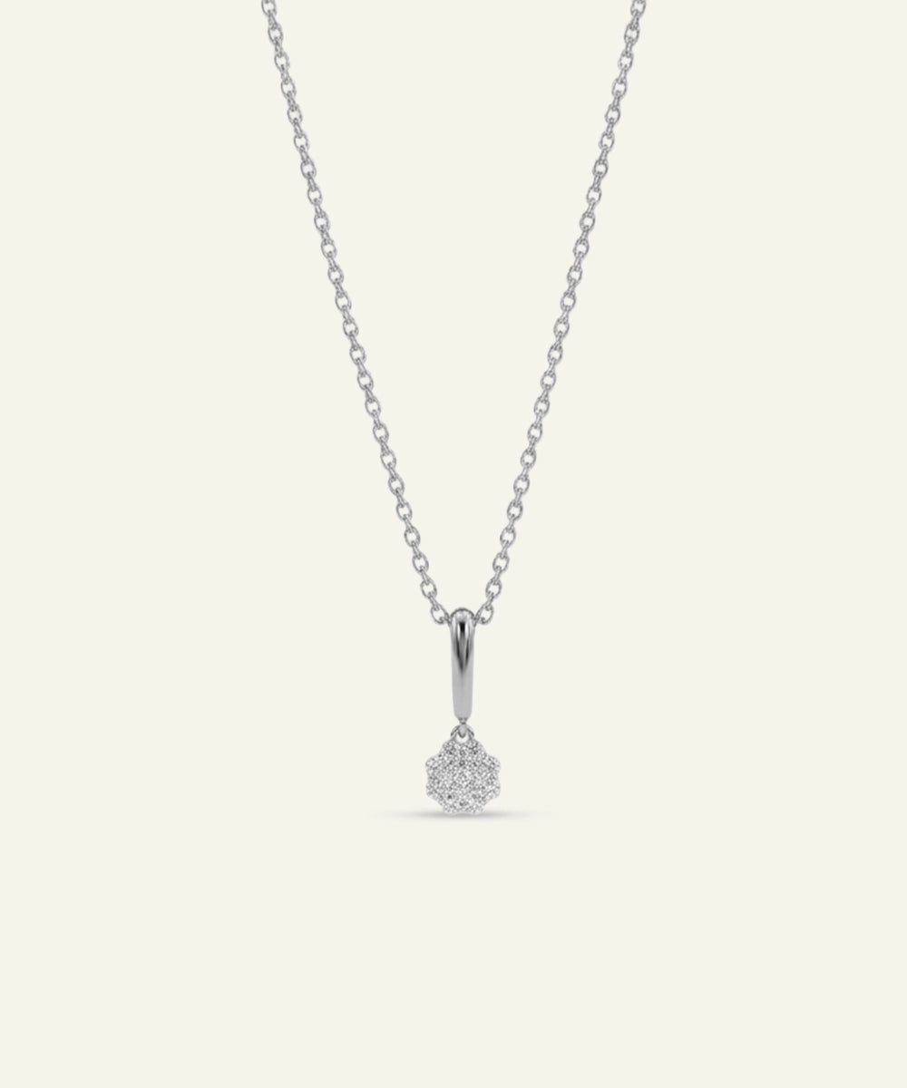 Silver necklace with a teardrop-shaped pendant on a light gray background