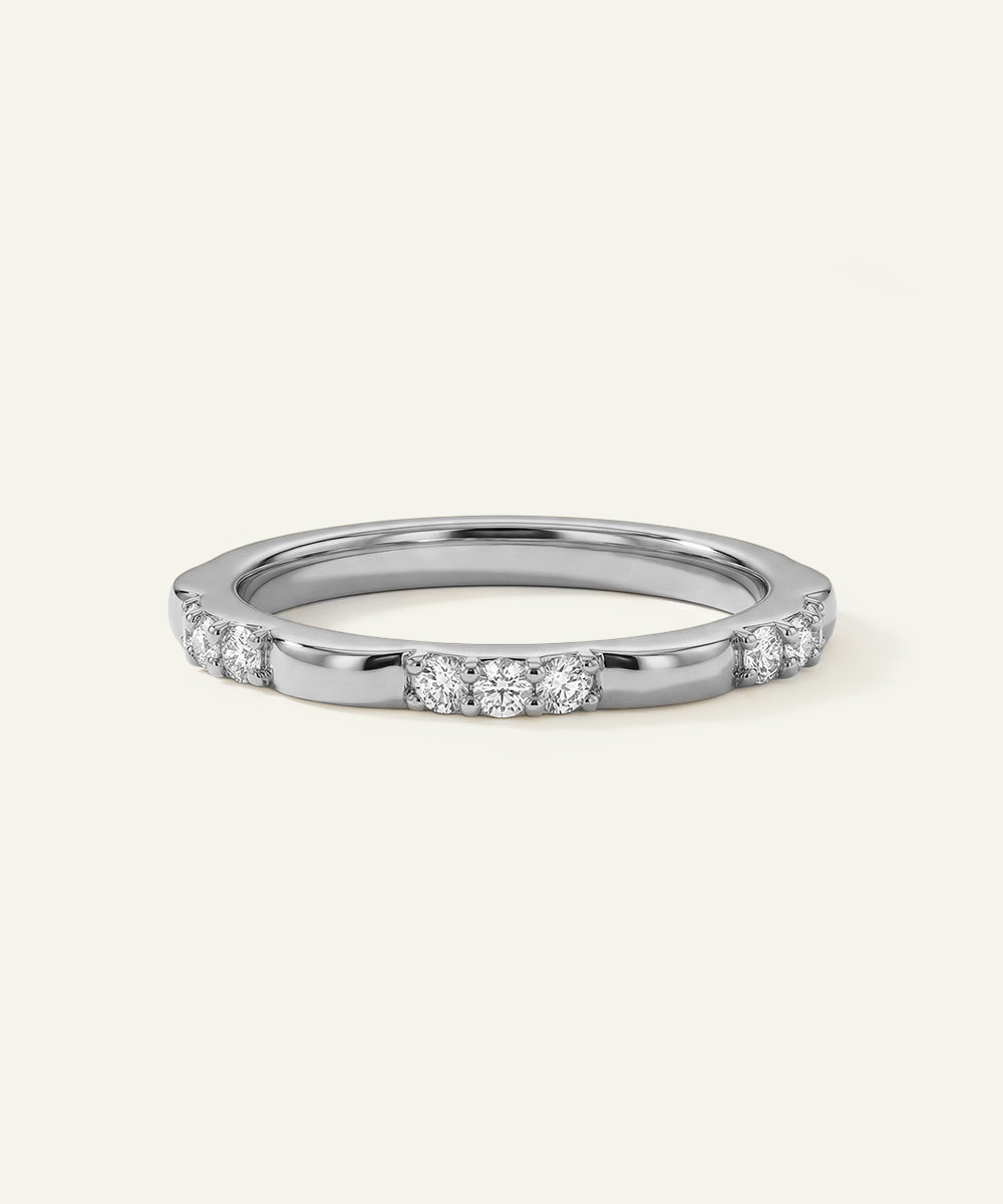 Silver ring with small diamonds on a white background