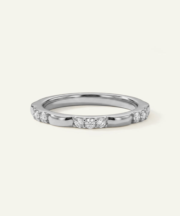 Silver ring with small diamonds on a white background