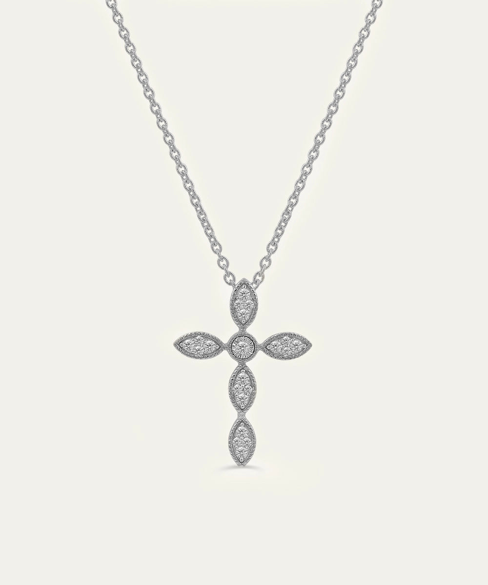 Silver cross pendant necklace on a light gray background