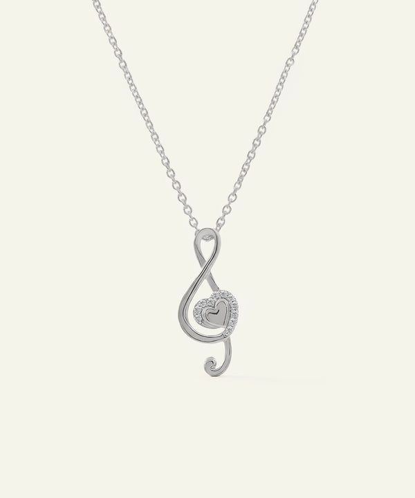 Silver treble clef necklace on a white background