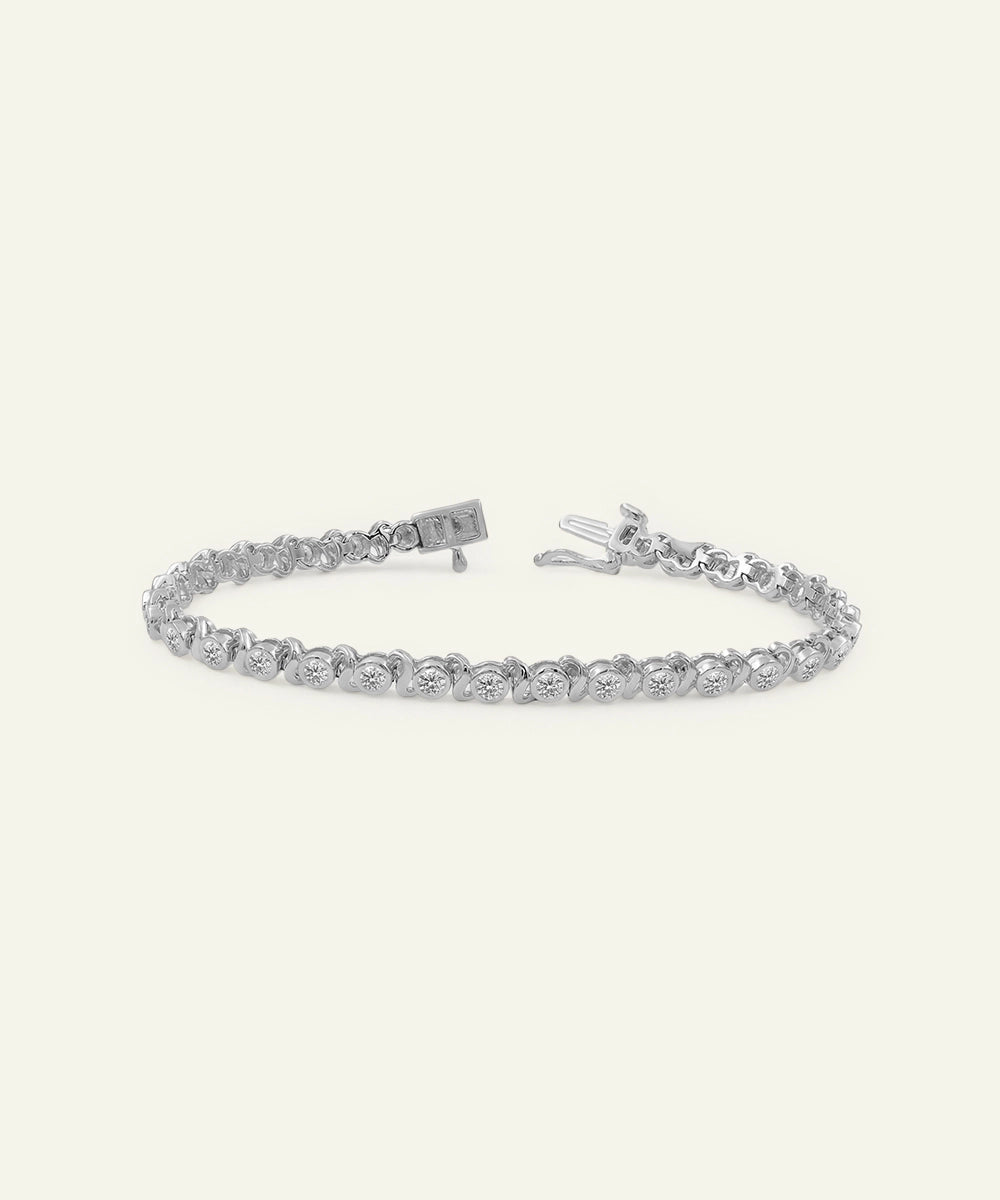 Silver bracelet with clear stones on a white background