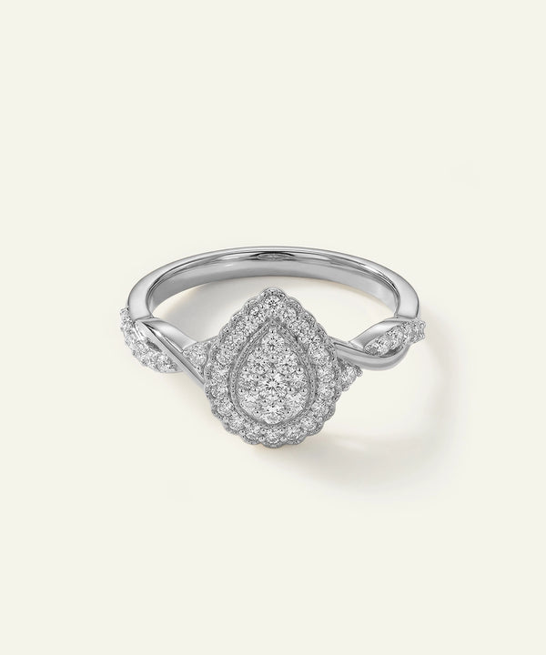 Silver ring with diamond accents on a light gray background