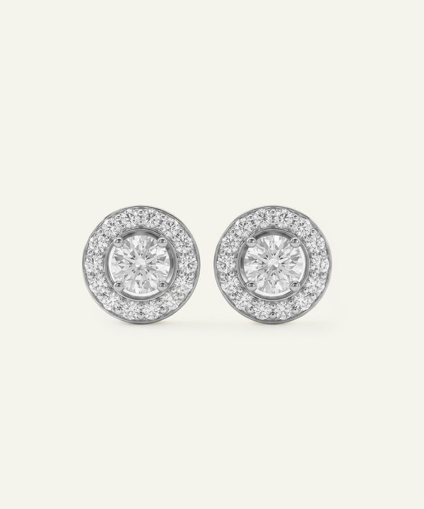Pair of diamond stud earrings on a light gray background