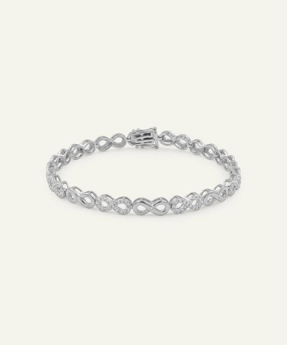 Silver bracelet with interlocking design on a white background