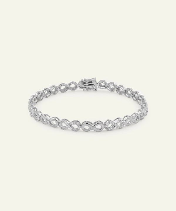Silver bracelet with interlocking design on a white background