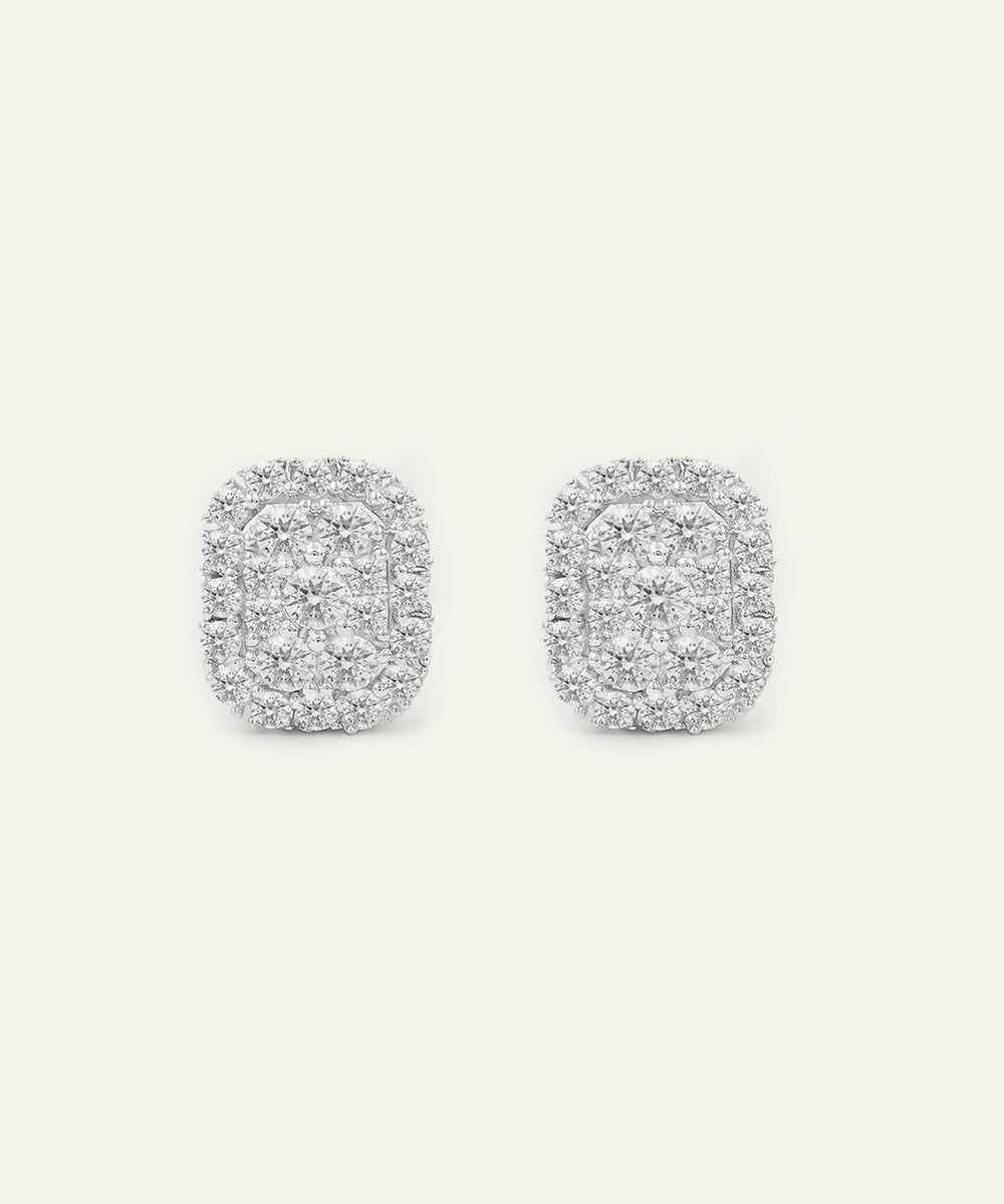 Pair of silver earrings with a textured design on a white background