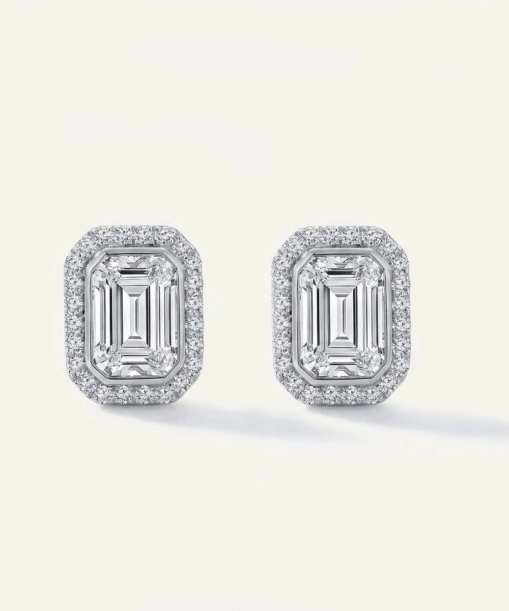 Pair of diamond earrings on a light gray background