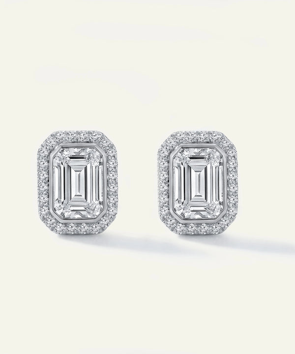 Pair of diamond earrings on a light gray background