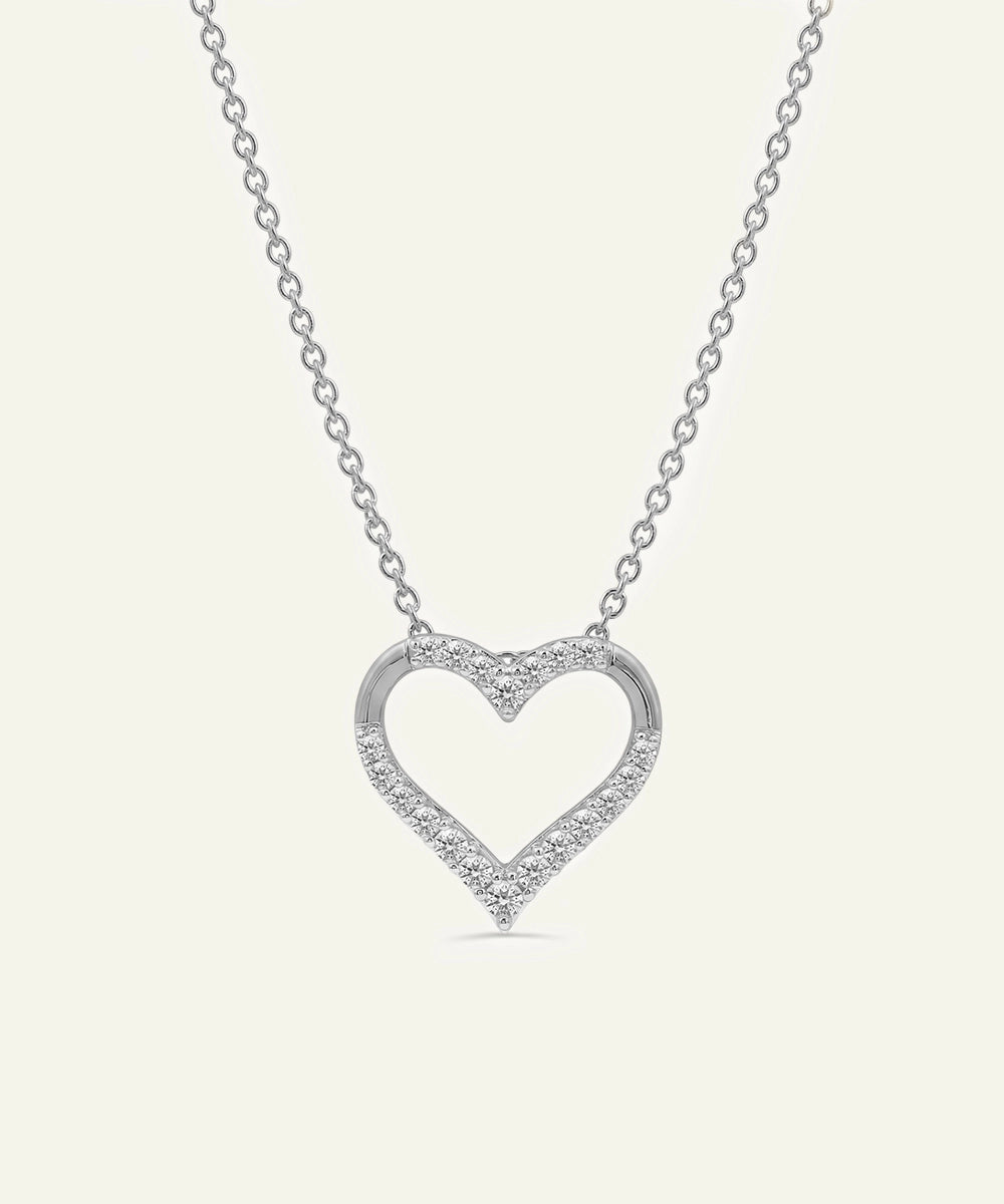 Heart-shaped diamond necklace on a white background