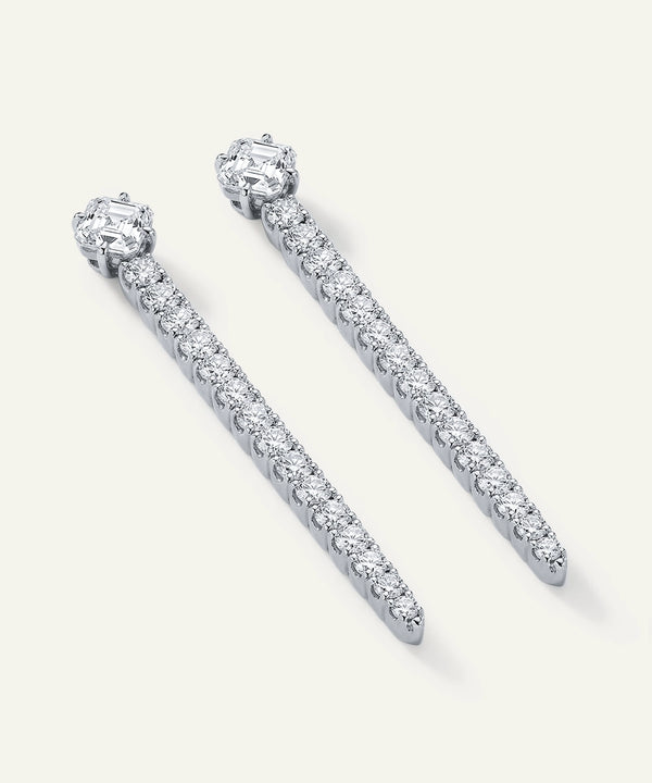 Pair of diamond earrings on a light gray background