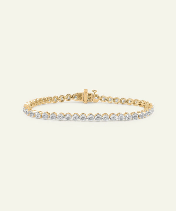 Gold bracelet with diamonds on a white background