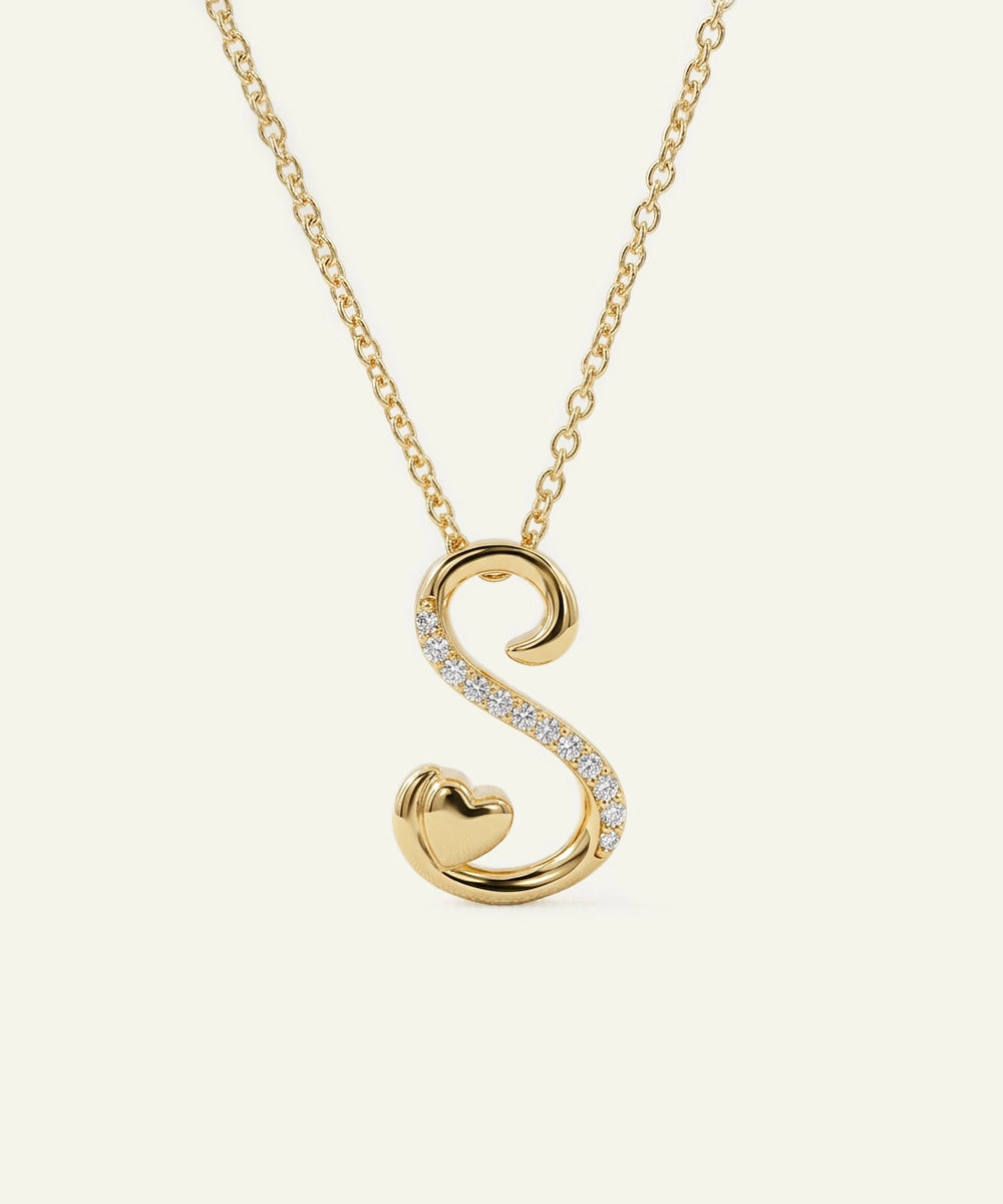 Gold necklace with a 'S' shaped pendant on a white background