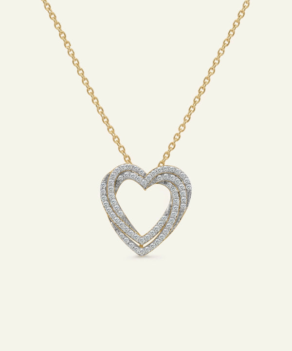 Heart-shaped diamond necklace on a gold chain against a white background