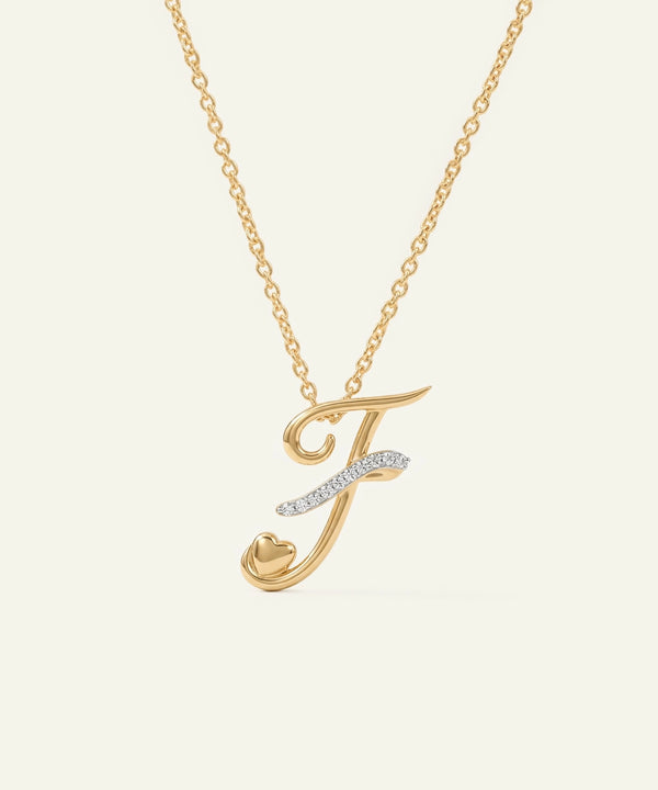 Gold necklace with a letter 'J' pendant on a light beige background