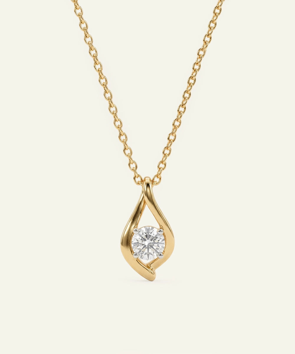 Gold necklace with a diamond pendant on a light beige background