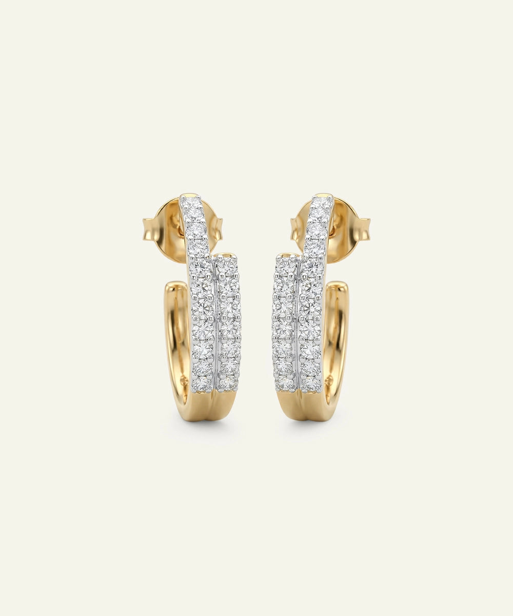 Gold and silver hoop earrings on a light gray background
