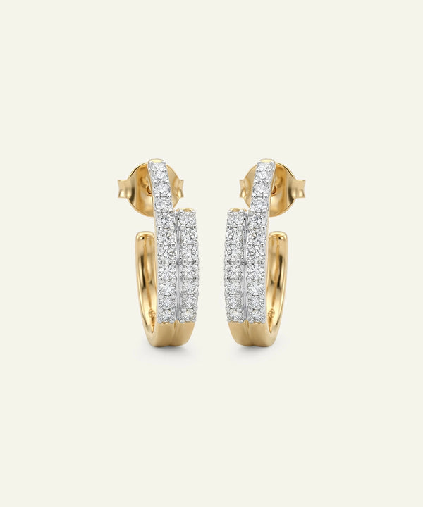 Gold and silver hoop earrings on a light gray background