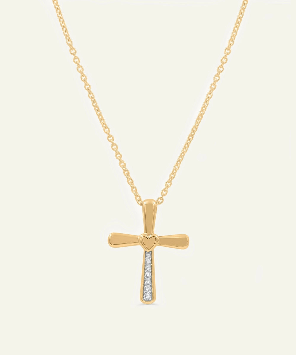 Gold cross necklace with heart detail and small diamonds on a white background