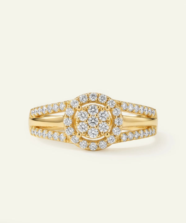 Gold ring with diamond accents on a light beige background