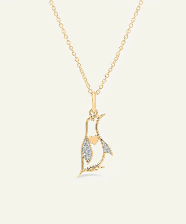 Gold necklace with a leaf-shaped pendant on a white background