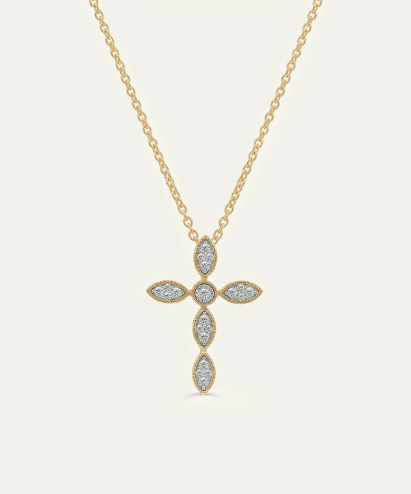 Gold necklace with a cross pendant on a light gray background