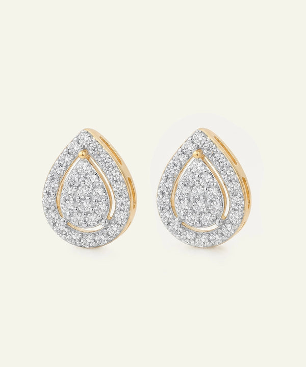 Teardrop-shaped earrings with gold and diamond accents on a light beige background