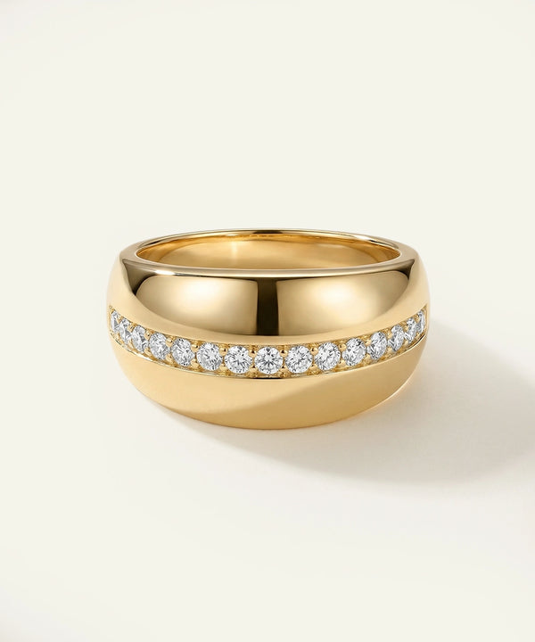 Gold ring with diamond accents on a light background