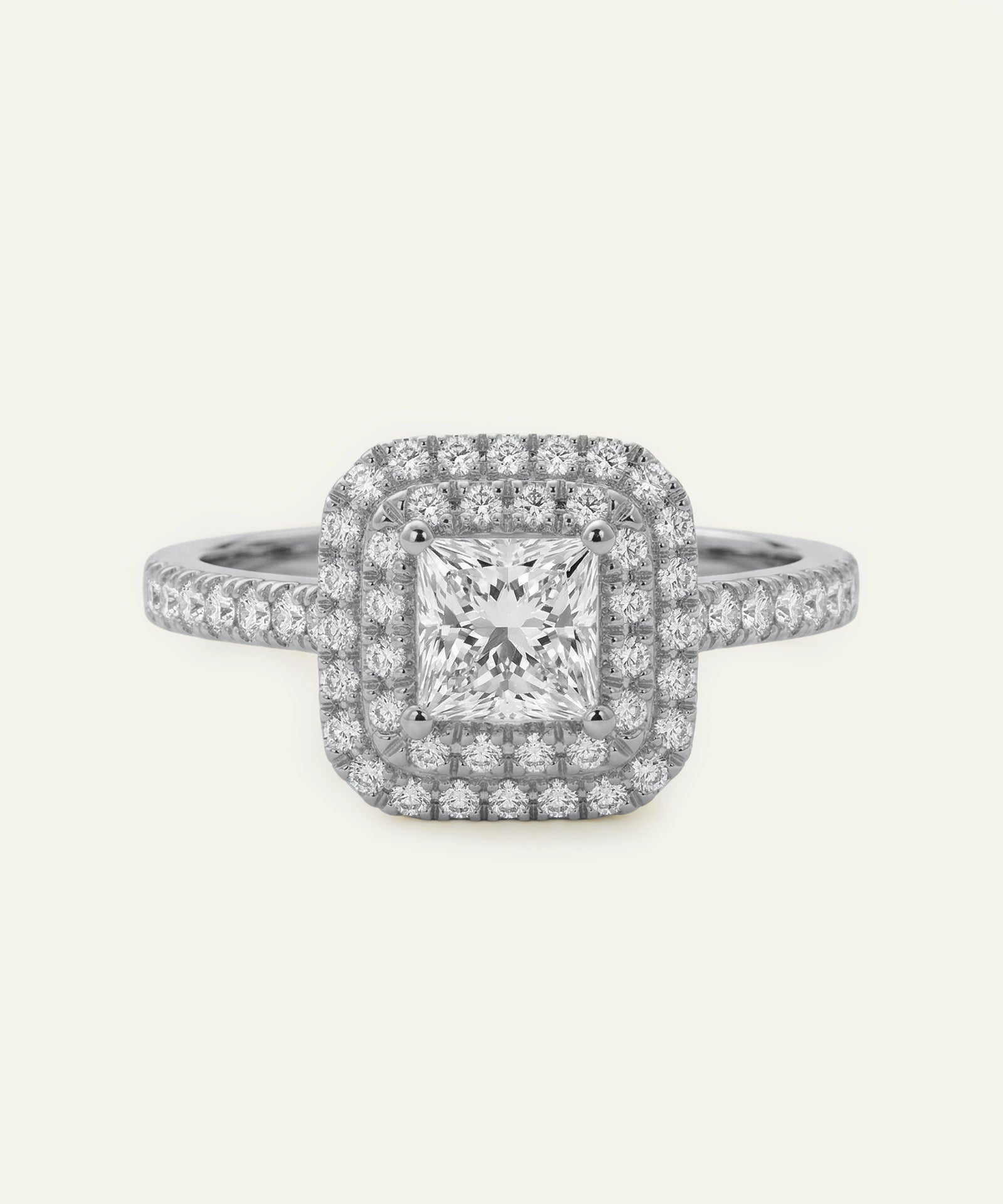 Diamond ring with a square-cut center stone on a white background
