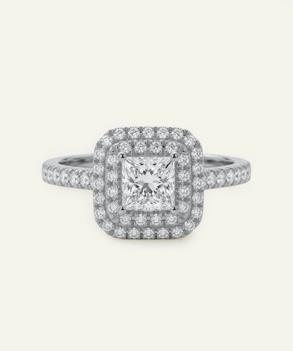 Diamond ring with a square-cut center stone on a white background