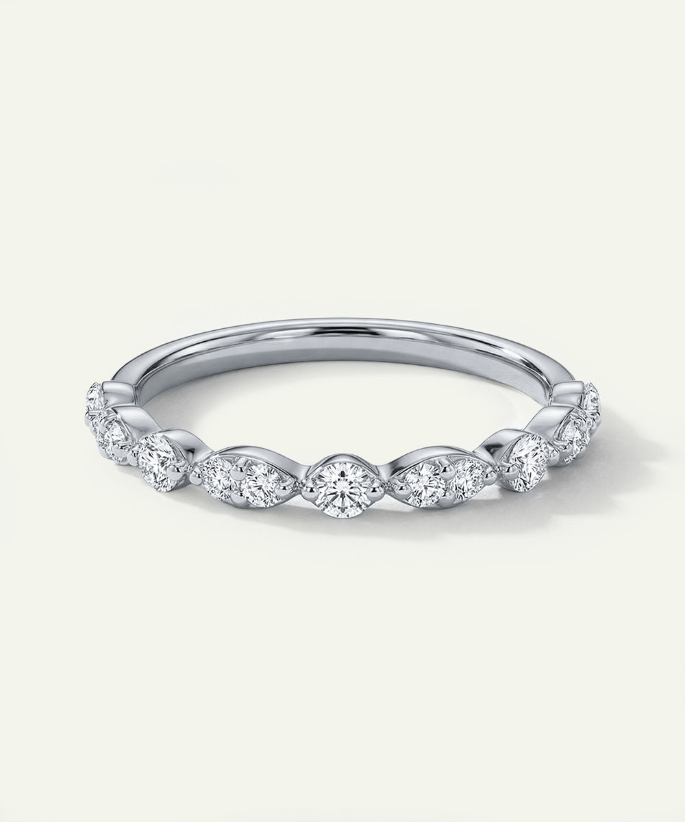 Silver ring with diamond accents on a light gray background