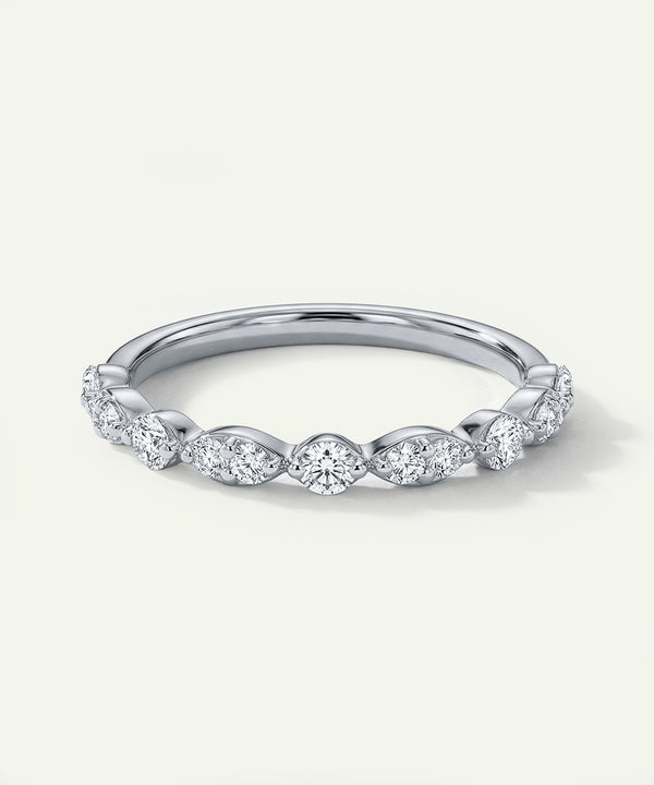 Silver ring with diamond accents on a light gray background
