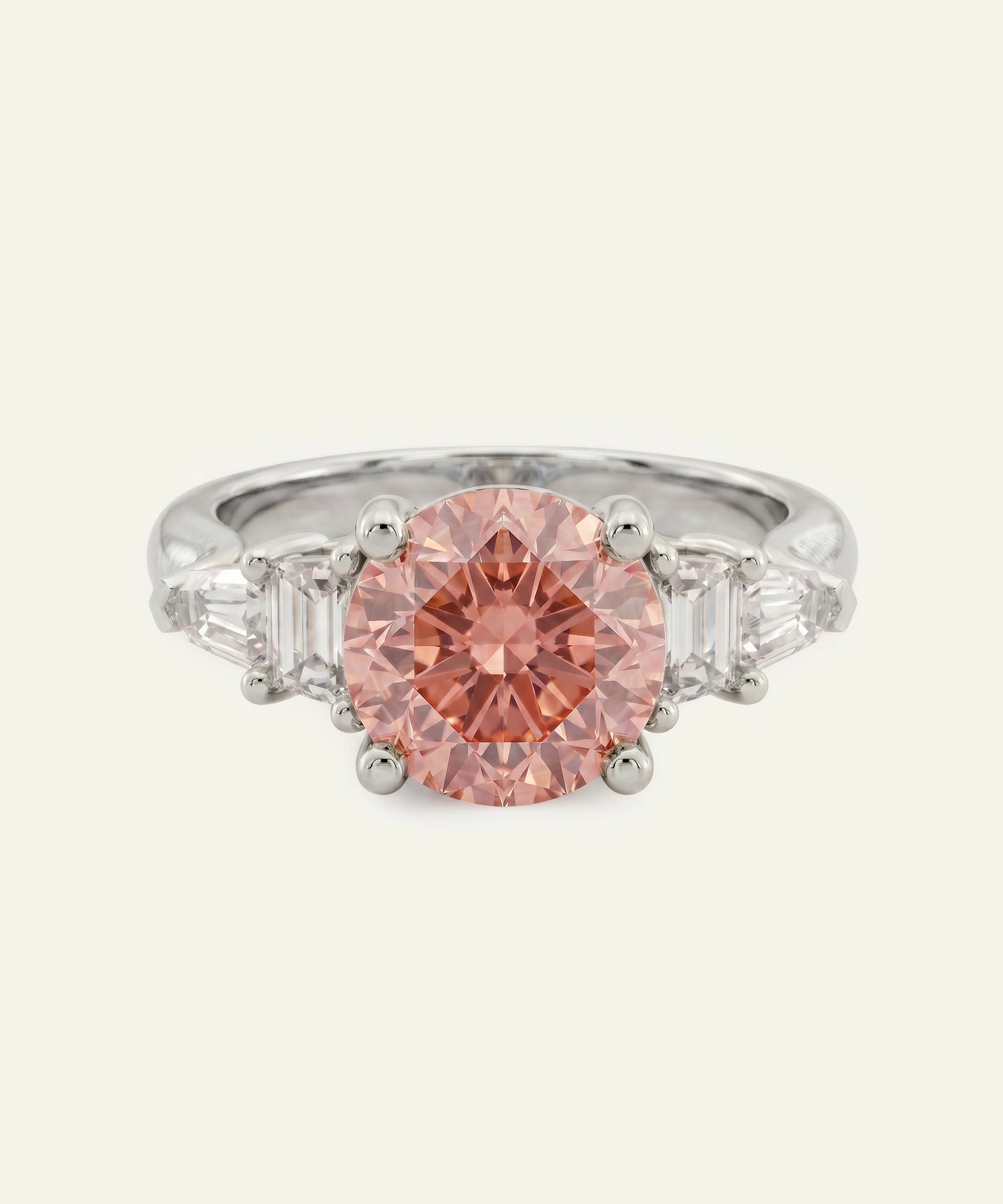 Ring with a pink diamond and silver setting on a white background